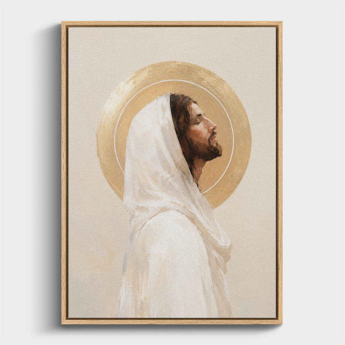 Framed wall art featuring a painted portrait of Jesus Christ in profile with a white veil and a gold halo, shown against a light neutral background.