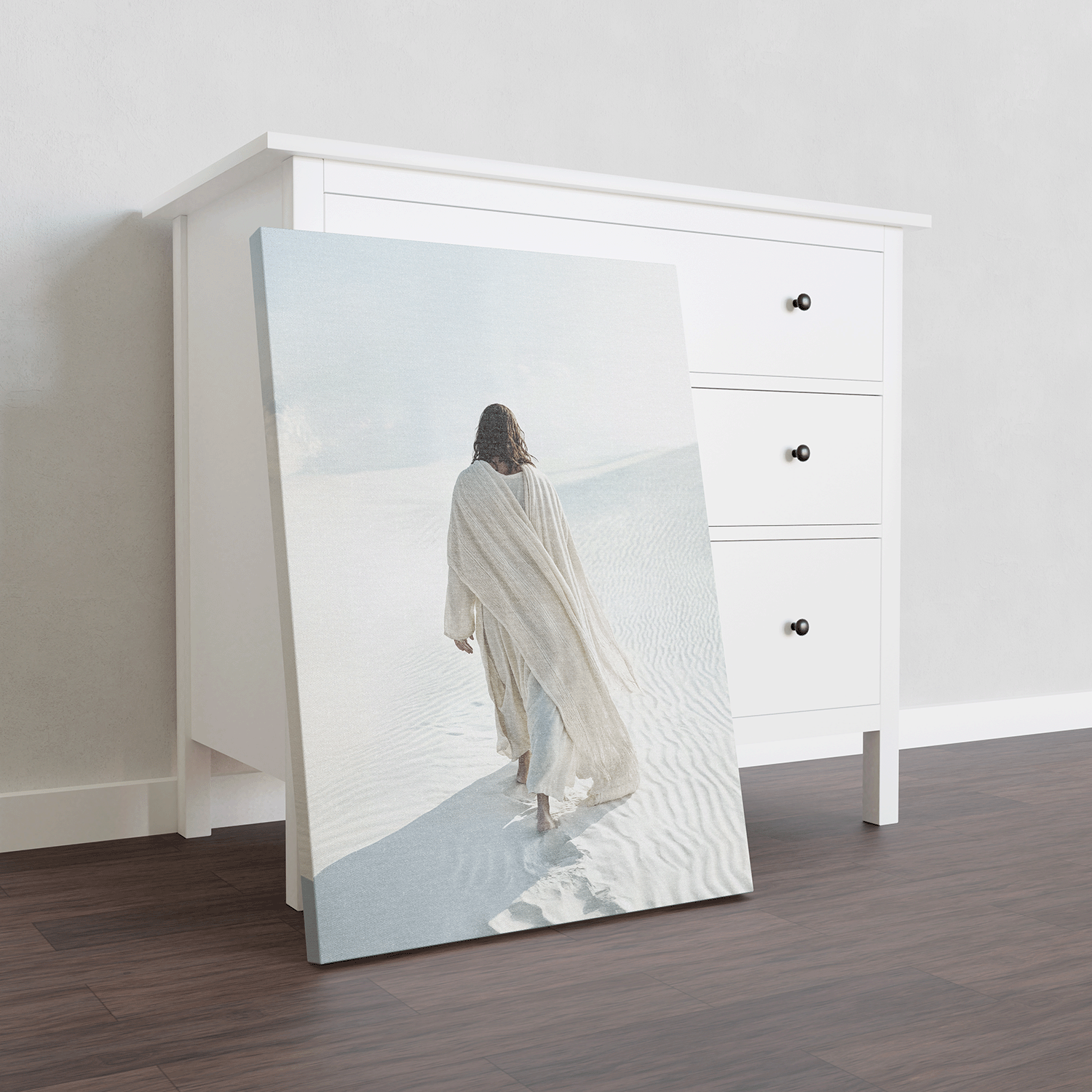 Christian wall art featuring Jesus walking alone through white sand dunes